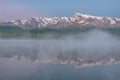 Mountains lake fog reflection dawn summer Royalty Free Stock Photo