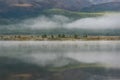 Mountains lake fog trees forest reflection Royalty Free Stock Photo