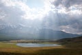 Mountains lake sun rays light clouds sky Royalty Free Stock Photo