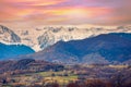 Mountains landscape in autumn. View of arable fields in the valley and mountain ridge covered with snow during sunset Royalty Free Stock Photo