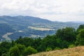 Mountains landscape, with layers of forest and some fields.