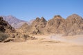 Mountains landscape and removing a row of ATVs in the dust Royalty Free Stock Photo