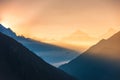 Mountains and low clouds at colorful sunrise in Nepal Royalty Free Stock Photo