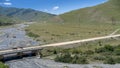 Mountains of North Ossetia, beautiful summer landscapes of the river valley, bridge and blue sky with clouds. Royalty Free Stock Photo