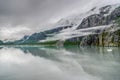 Mountains & Ocean with cloudy sky at Glacier Bay Alaska Royalty Free Stock Photo