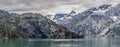 Mountains & Ocean with cloudy sky at Glacier Bay Alaska Royalty Free Stock Photo