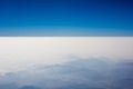 Misty mountains out of plane. Mountains in fog. Clear blue sky over the fog on horizon..