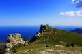 Mountains partially covered with grass. summer, the republic of Crimea. interesting stones of a bizarre shape as a result of many