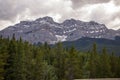 Mountains peak in Banff National Park, Alberta, Canada. Snow-capped mountain peaks, coniferous forest and amazing cloudy day. Royalty Free Stock Photo