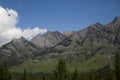 Mountains peak in Banff National Park, Alberta, Canada. Snow-capped mountain peaks, coniferous forest and amazing cloudy day. Royalty Free Stock Photo