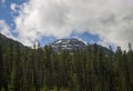 Mountains peak in Banff National Park, Alberta, Canada. Snow-capped mountain peaks, coniferous forest and amazing cloudy day. Royalty Free Stock Photo