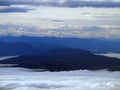 Mountains peaking through the clouds Royalty Free Stock Photo