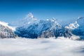 Mountains peaks and clouds in the valley. Natural landscape. Mountain range through the clouds. Landscape in the summertime. Royalty Free Stock Photo