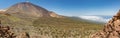 Mountains and pine tree forest near volcano Teide, partly covered by the clouds. Bright blue sky. Teide National Park, Tenerife, Royalty Free Stock Photo