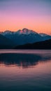 Mountains provide stunning backdrop to serene sunset over water