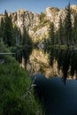 Mountains Reflect in the Water of a Calm Section of the Tuolumne River Royalty Free Stock Photo