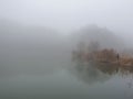 Mountains reflection on the lake fog fishing Royalty Free Stock Photo