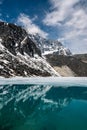 Mountains reflection in partly frozen lake Royalty Free Stock Photo