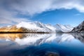 Mountains and reflections on water at night. Winter landscape. The sky with stars and clouds in motion. Nature as a background. Royalty Free Stock Photo