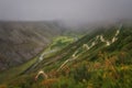 Mountains road pass steep serpentine river valley fog Royalty Free Stock Photo