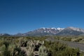 Mountains road trip. Snow mountain, blue sky and asphalt road Royalty Free Stock Photo