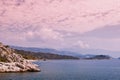 Mountains, sea and blue sky with clouds, seascape, stony seashore