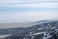 Mountains with smog rising from town. Visible border of clean and dirty air. Royalty Free Stock Photo