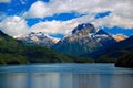 Mountains with snow above blue lake Royalty Free Stock Photo