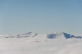 Mountains and snow barkhans on the background of the blue sky