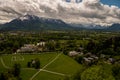 Mountains with snow, city with green grass and trees