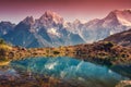Mountains with snow covered peaks, red sky reflected in lake Royalty Free Stock Photo