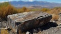 mountains on a sunny day with a huge rock block in the foreground