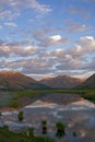 Mountains in sunset light and reflections in the lake. Royalty Free Stock Photo