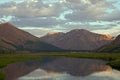 Mountains in sunset light and reflections in the lake. Royalty Free Stock Photo