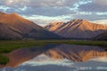 Mountains in sunset light and reflections in the lake. Royalty Free Stock Photo