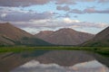 Mountains in sunset light and reflections in the lake. Royalty Free Stock Photo