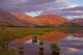 Mountains in sunset light and reflections in the lake. Royalty Free Stock Photo