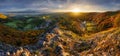 Mountains at sunset in Slovakia - Vrsatec. Landscape with orange trees in fall, colorful sky with golden sunbeams. Panorama