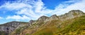 Mountains, sunshine and blue sky with nature, clouds and stone with landscape and weekend break. Empty, rock and grass Royalty Free Stock Photo