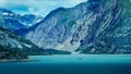 the mountains are surrounded by blue water, with boats sailing through the middle Royalty Free Stock Photo