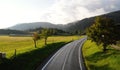 Mountains Tatra landscape with green forest, blue clouds and meadow. Road in the middle