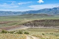 Mountains tower above the Oakley Dam and Lower Goose Creek Reservoir at Oakley, Idaho, USA