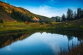 Mountains and trees reflecting in the still water at sunset. Mountain lake in BC Canada. Beautiful British Colombia Royalty Free Stock Photo