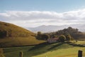 Mountains valley with house and road. Pyrenees autumn landscape. Scenic meadows and agricultural fields in hills valley. Royalty Free Stock Photo