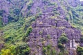 Mountains in Vietnam, Close up of the rock on the side of steep cliff face on a mountain and Surrounded by green trees In Hanoi, Royalty Free Stock Photo