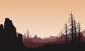 The mountains view at dusk from the edge of the cliff with the silhouettes of dry trees around it Royalty Free Stock Photo