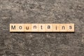 mountains word written on wood block. mountains text on cement table for your desing, concept Royalty Free Stock Photo