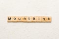 mountains word written on wood block. mountains text on cement table for your desing, concept Royalty Free Stock Photo