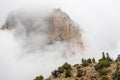 The mountains of Zion National Park in Utah with a heavy overcast and clouds dramatically passing in from of the peaks
