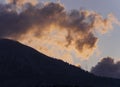 Mountainside with pines, fir trees and clouds at sunset on the island of Evia in Greece Royalty Free Stock Photo